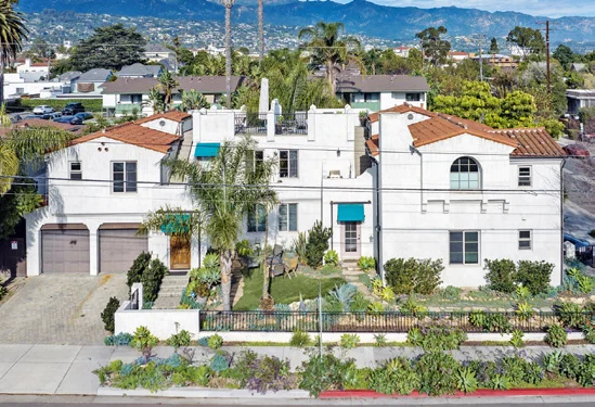 Andalusian-style corner duplex with white stucco and red tile roofs at 330 W. Canon Perdido, Santa Barbara